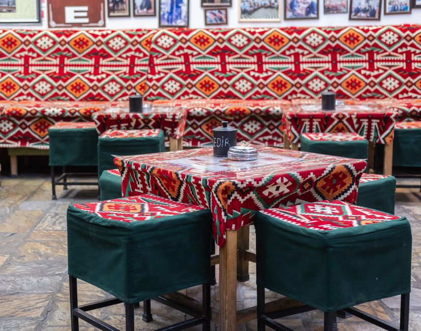 People enjoying espresso in a bustling cafe in Tirana, Albania, showcasing the local coffee culture.
