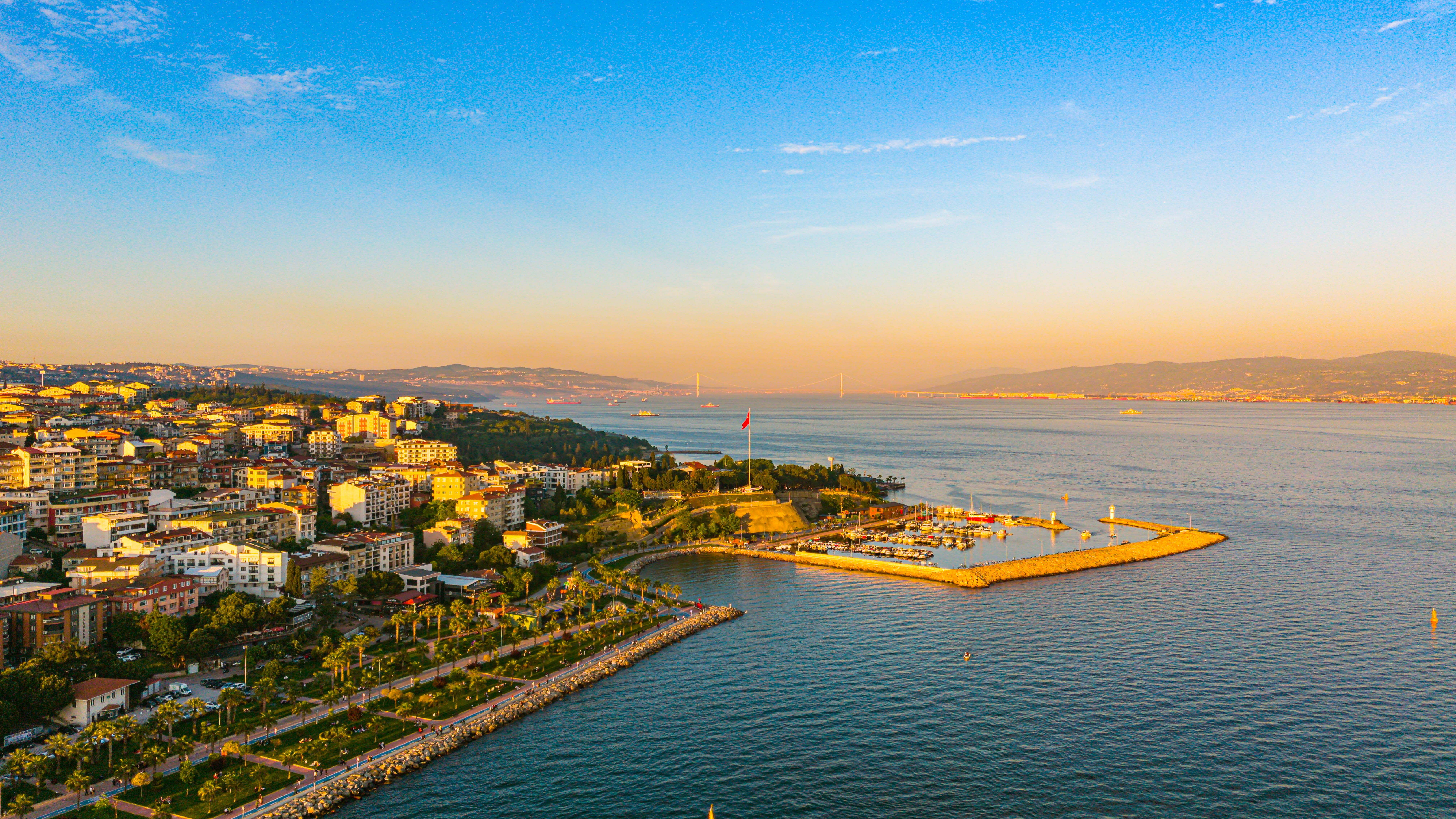 Scenic aerial view of Darıca coastline in Kocaeli, Türkiye, with vibrant sunset hues over the sea.