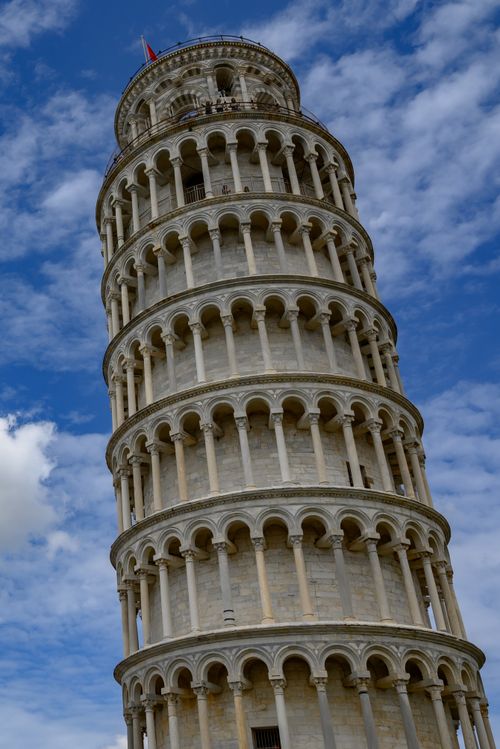 Free Iconic Leaning Tower of Pisa in Italy, captured under a vibrant blue sky. Stock Photo