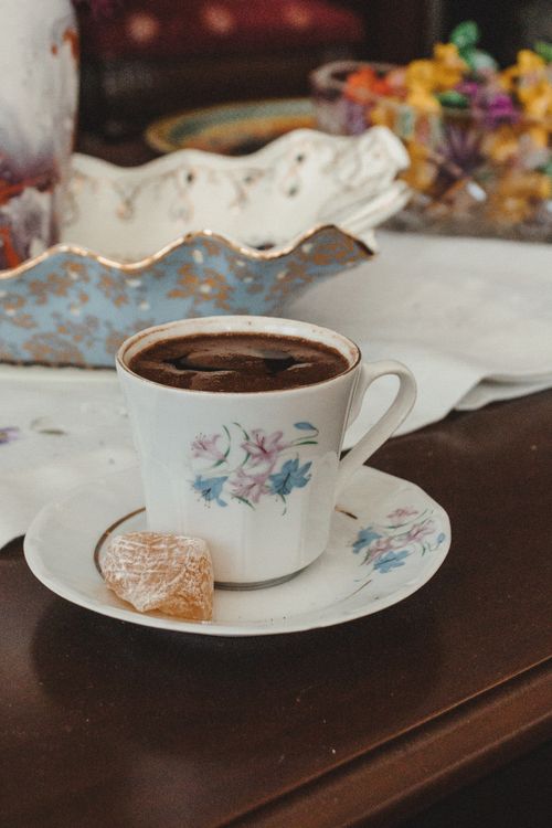 Free A floral porcelain cup of Turkish coffee with a sweet delight, exuding a cozy and inviting atmosphere. Stock Photo