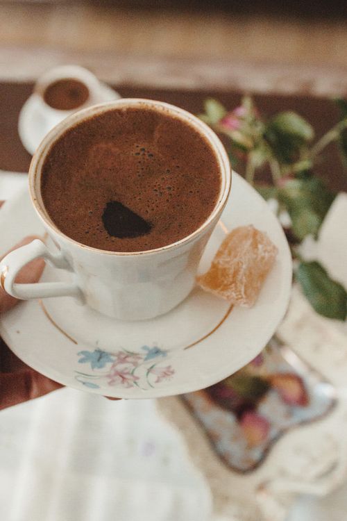 Free Turkish coffee served in a floral cup with Turkish delight. Classic and warm ambiance. Stock Photo