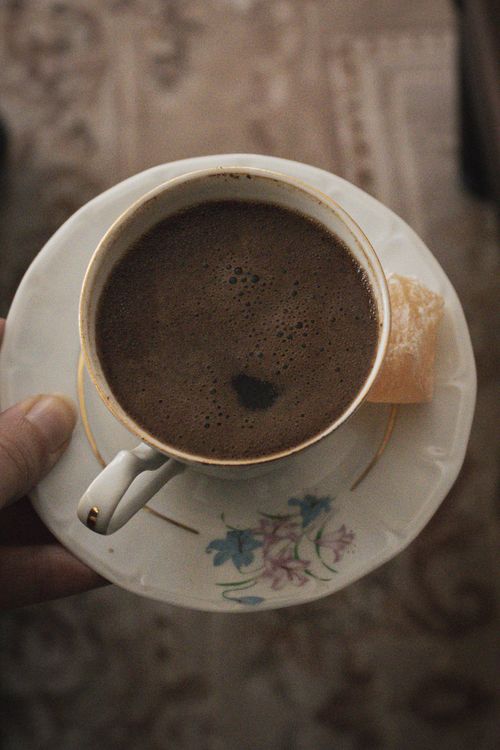 Free Close-up of Turkish coffee with a Turkish delight served in a floral cup. Stock Photo