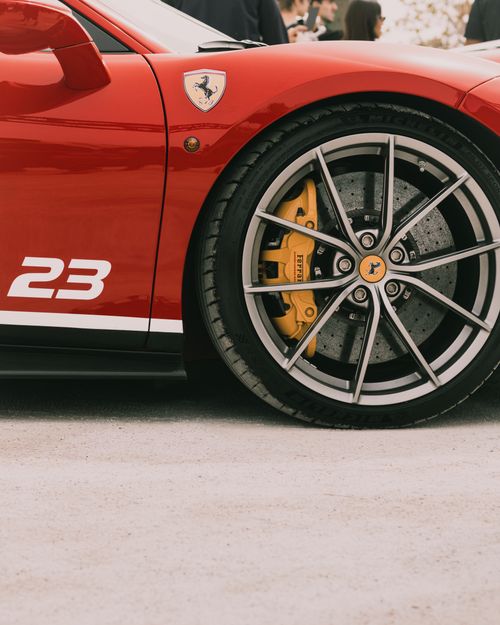 Free Close-up of a red sports car wheel, highlighting luxury and performance. Stock Photo