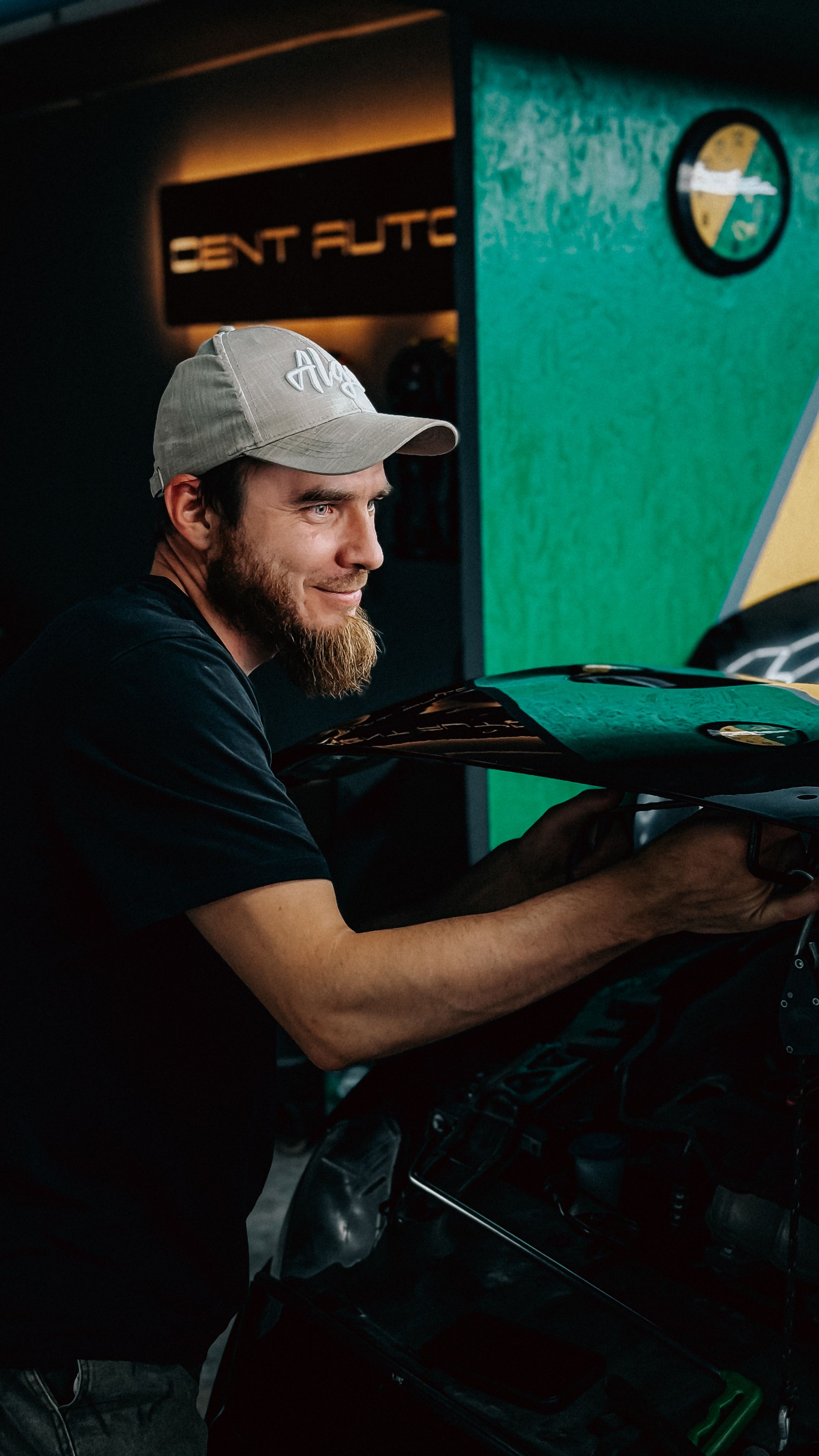 Auto technician working on a vehicle in a professional garage