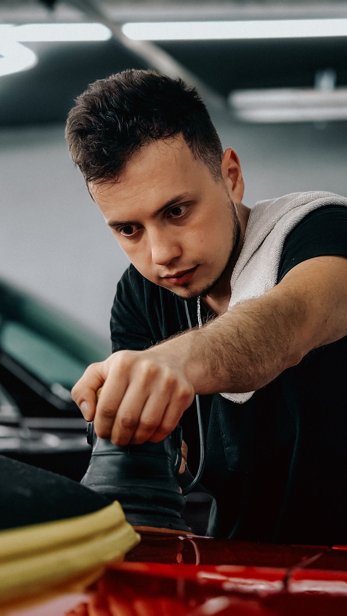 Focused car detailer working on a vehicle