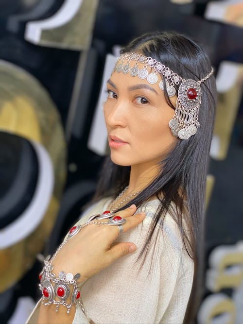 Woman In White Shirt Wearing Silver and Red Tiara