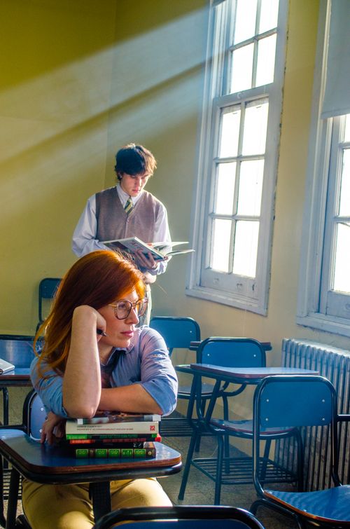 Free Students reflect in a sunlit Buenos Aires classroom, creating a thoughtful mood. Stock Photo