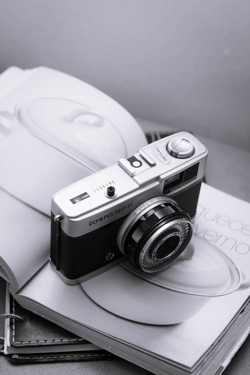 Black and Silver Camera on White Magazine