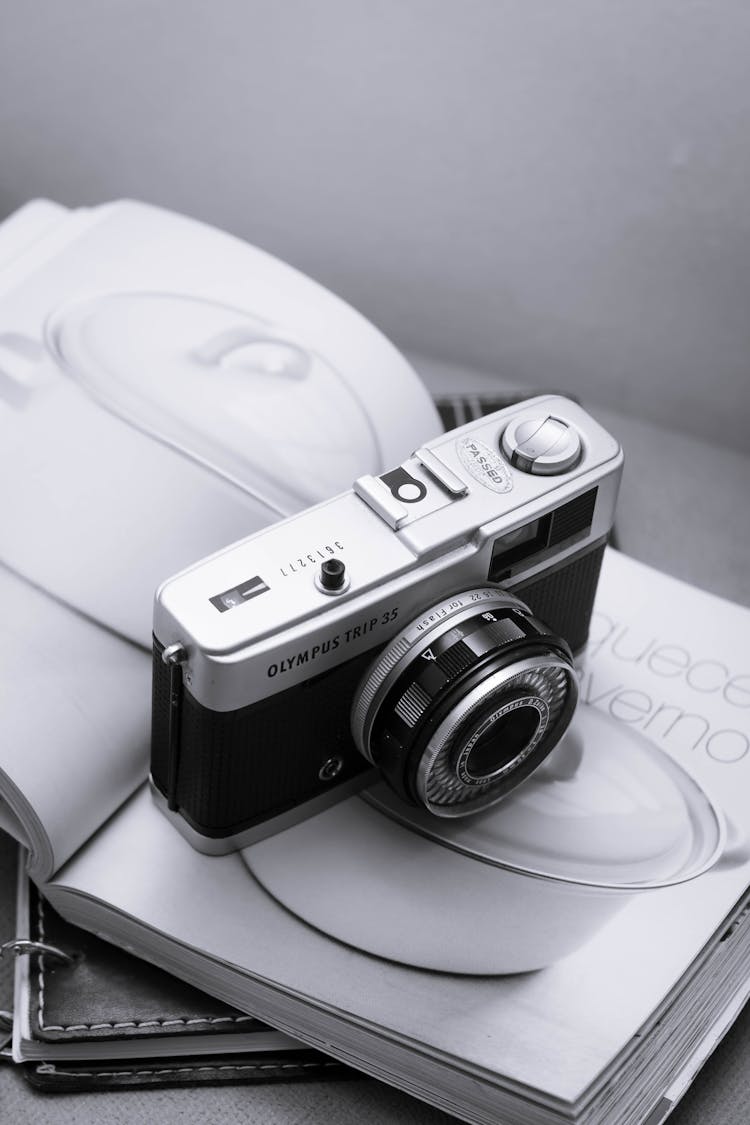 Black And Silver Camera On White Magazine