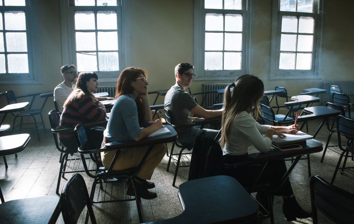 Students attentive in class by the window