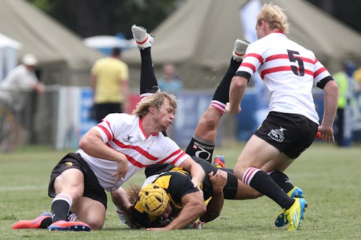 Rugby players in action during a competitive match on a grassy field.