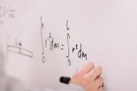 Person Writing On White Board