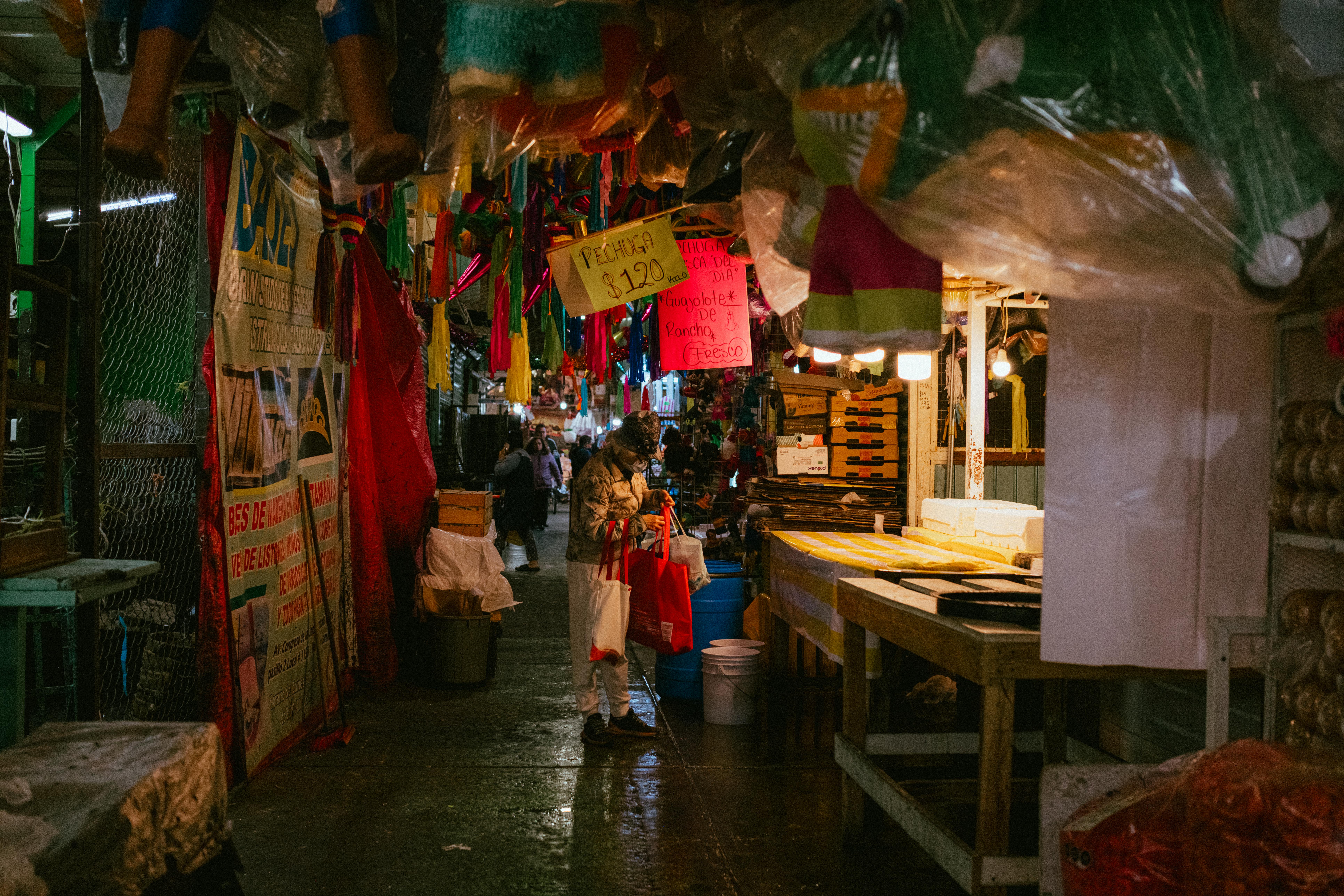 Colorful market in Ciudad de México with vibrant stalls and people shopping.