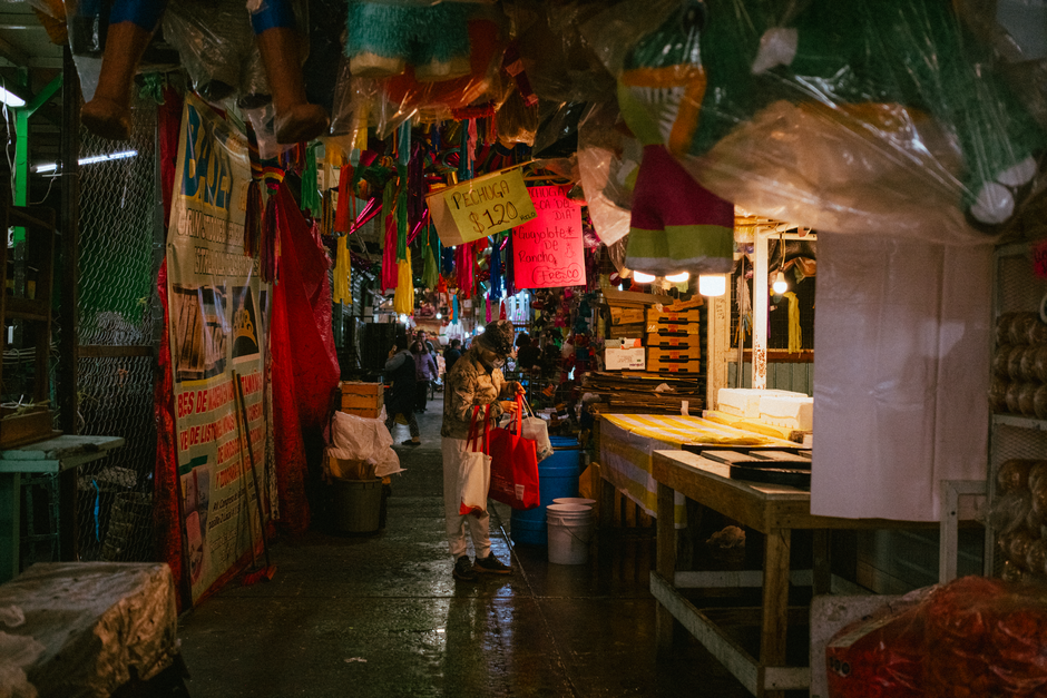 Colorful market in Ciudad de México with vibrant stalls and people shopping.