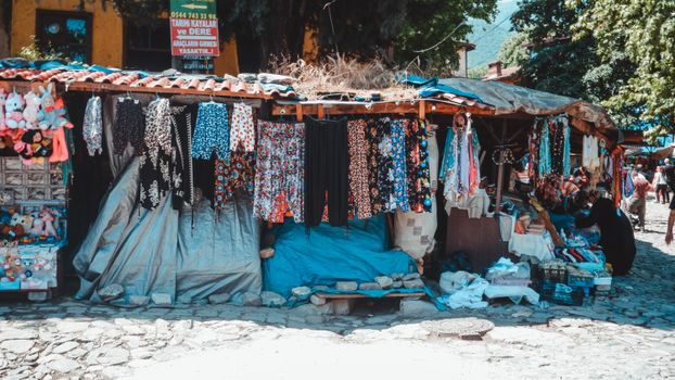 A vibrant outdoor market stall displaying colorful clothing and accessories.