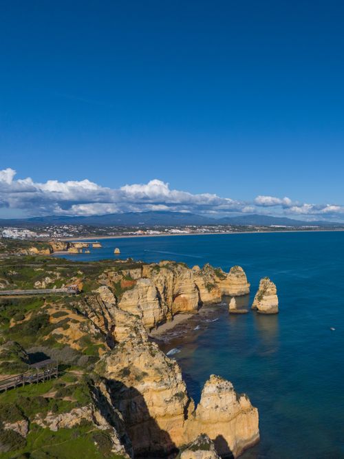 Free Stunning aerial view of the Ponta da Piedade cliffs and blue ocean in Lagos, Portugal. Stock Photo