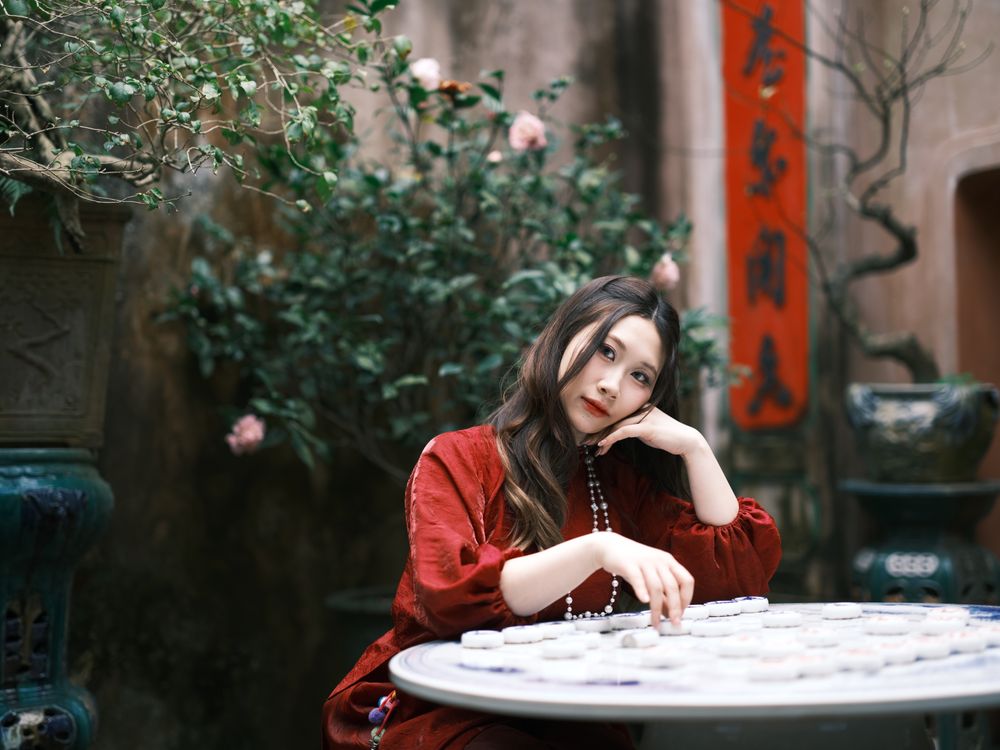 Woman in Red Dress Posing Outdoors by Table · Free Stock Photo
