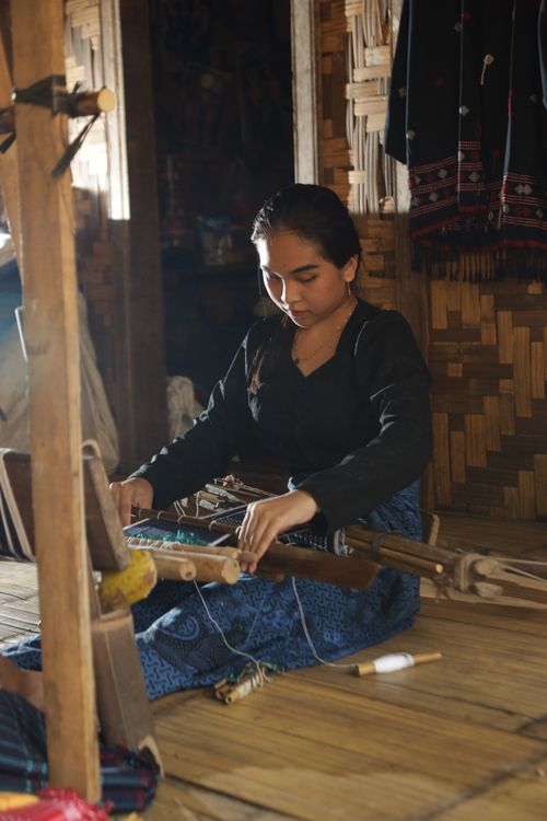 Young Woman Weaving on Traditional Loom Indoors · Free Stock Photo
