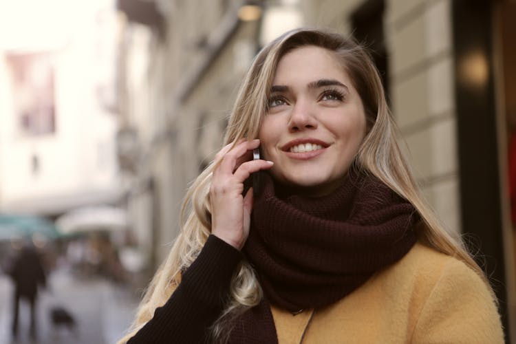 Woman In  Coffee Brown Coat Looking Up The Sky