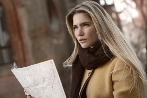 Woman In Brown Coat Holding A Map