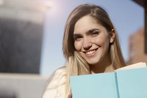 Smiling Woman in White Top