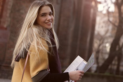 Woman Smiling While Holding Paper