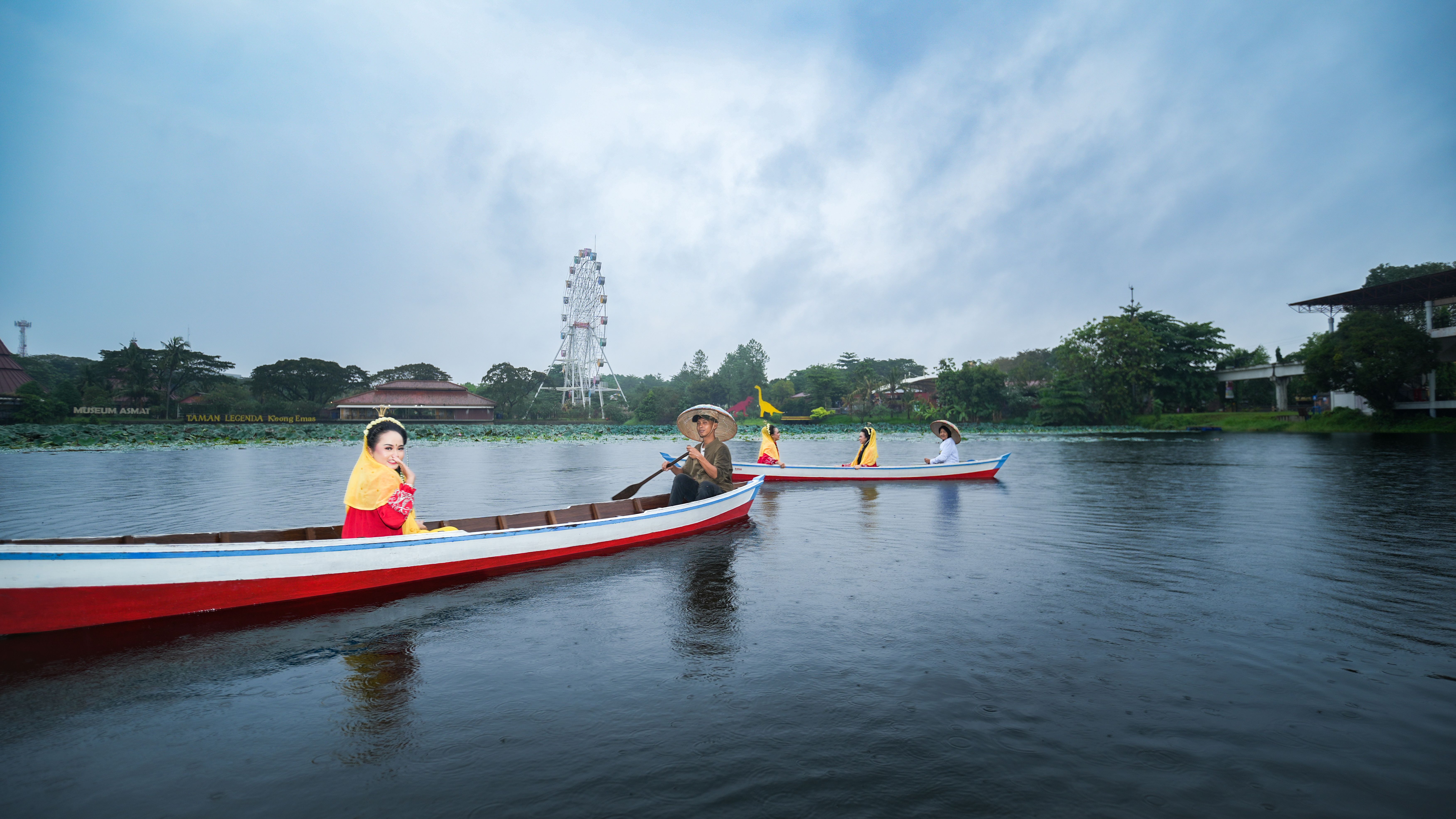 A serene boat ride showcasing traditional attire on a lake in Jakarta, Indonesia.