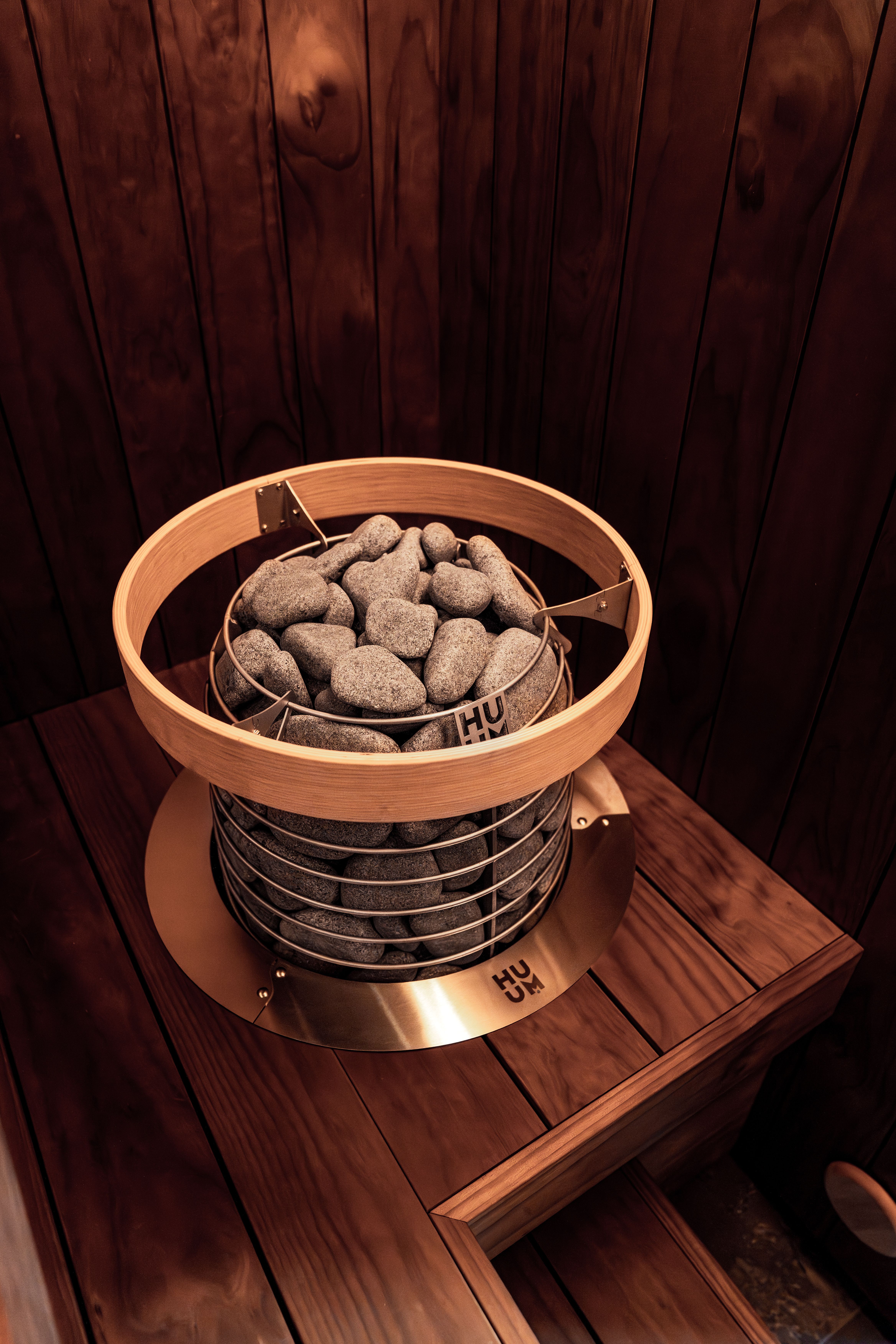 A stylish Nordic design sauna with an electric heater featuring wooden and metallic elements.