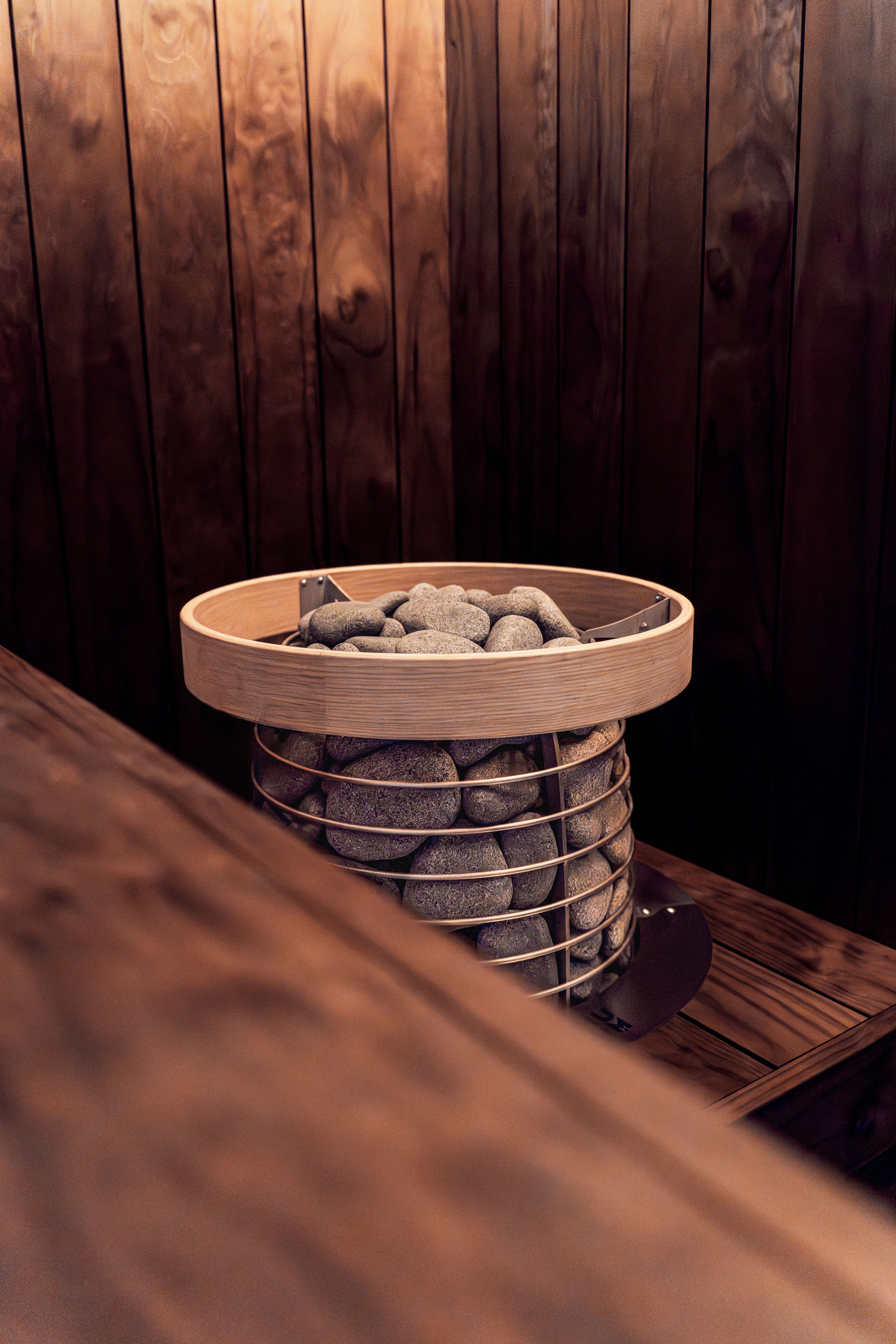 Experience relaxation in a modern Scandinavian wooden sauna with a sleek electric heater and soft LED lighting.