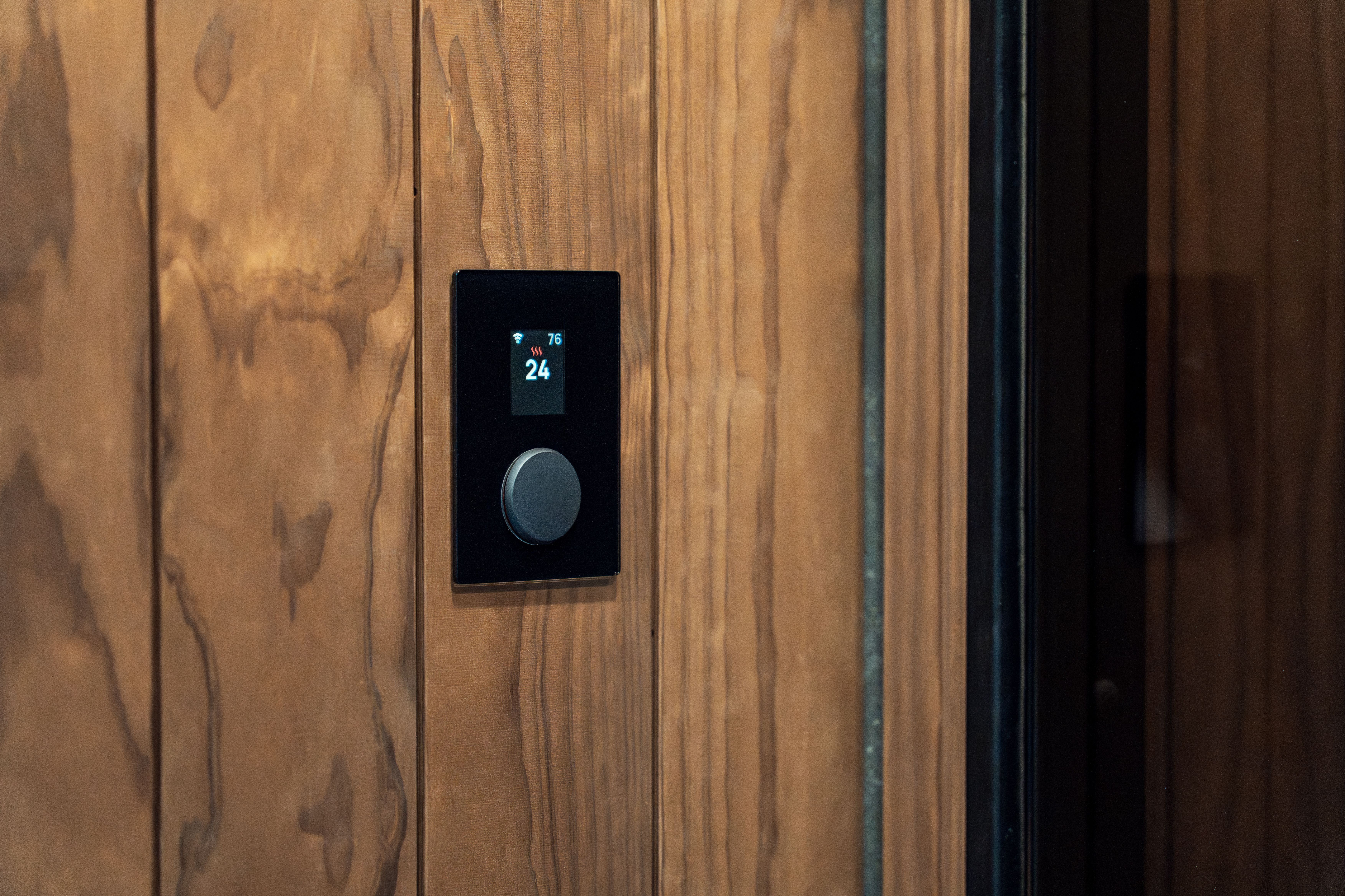 thermostat set to 68 degrees with a cozy bedroom in background