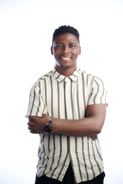 Man in a striped short-sleeve shirt on a white studio backdrop — Joshua Ngcongwane on Pexels