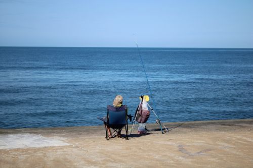 Free An adult enjoys a tranquil day fishing by the Black Sea in Samsun, Türkiye, capturing serene outdoor leisure. Stock Photo