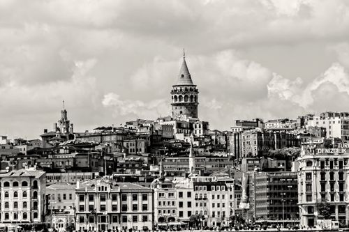 Free Monochrome cityscape showcasing the iconic Galata Tower in Istanbul under a cloudy sky. Stock Photo