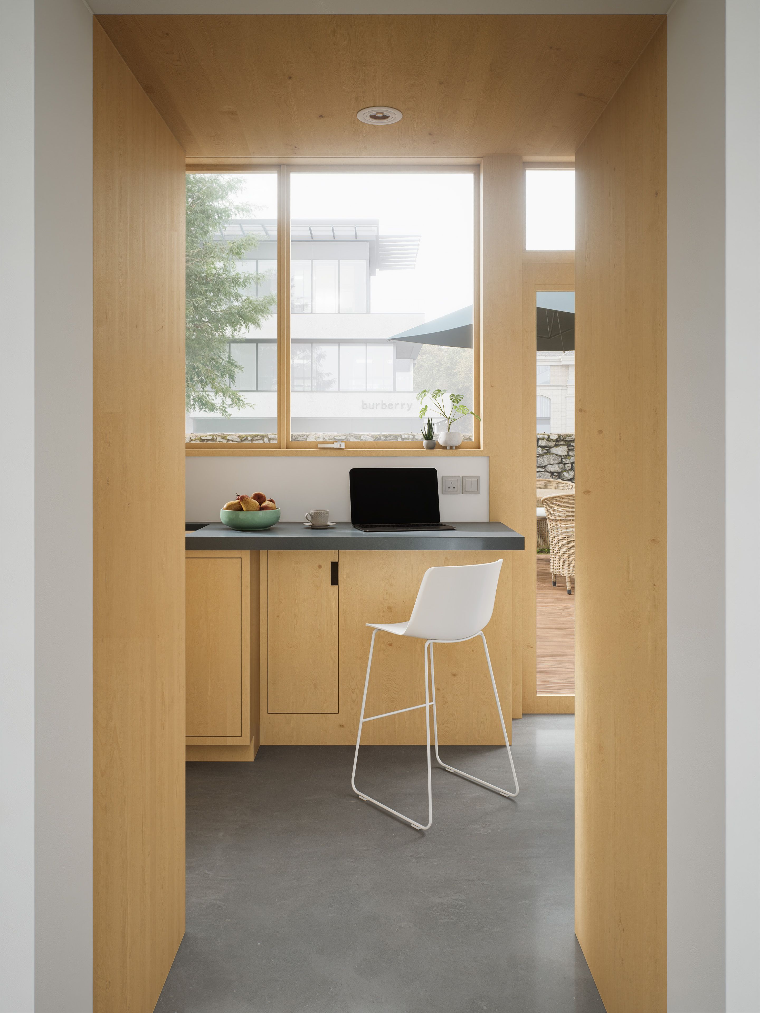 Contemporary workspace with sleek design, wooden accents, and ample natural light.