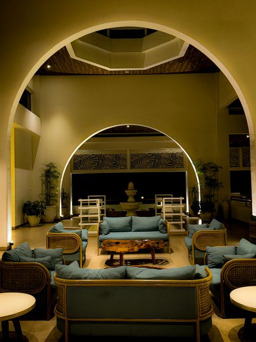 Free Sophisticated hotel lobby featuring modern furniture and warm ambient lighting for relaxation. Stock Photo