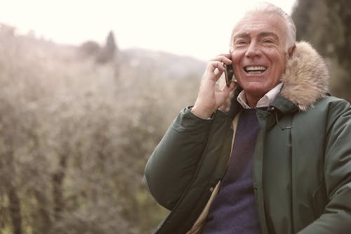 Free Man Wearing Gray Coat Using a Cellphone Stock Photo