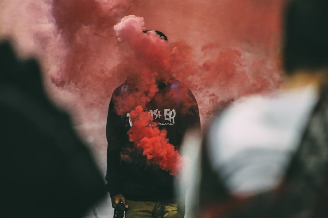 Free Person Standing Surrounded With Smoke Stock Photo