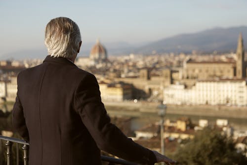 Man In Black Suit Looking At City Buildings