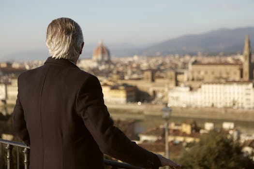 Elderly man gazes over Florence, capturing a scenic cityscape with the iconic Duomo.