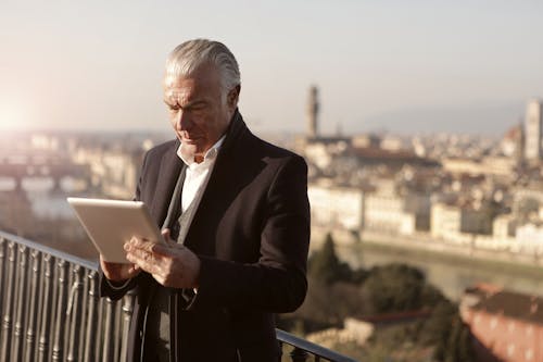 Man in Black Suit Jacket Using Macbook