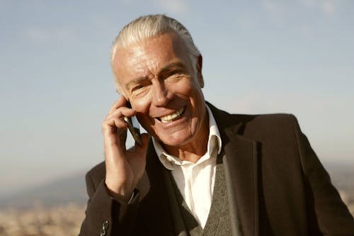Man in Black Suit Using A Cellphone