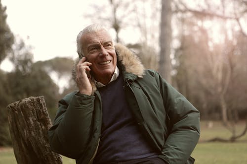 Man in Green Jacket and Purple Shirt