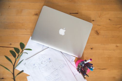 Macbook Air on Brown Wooden Table