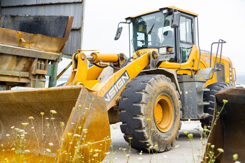 Close-up of an industrial loader in a worksite setting on a clear day