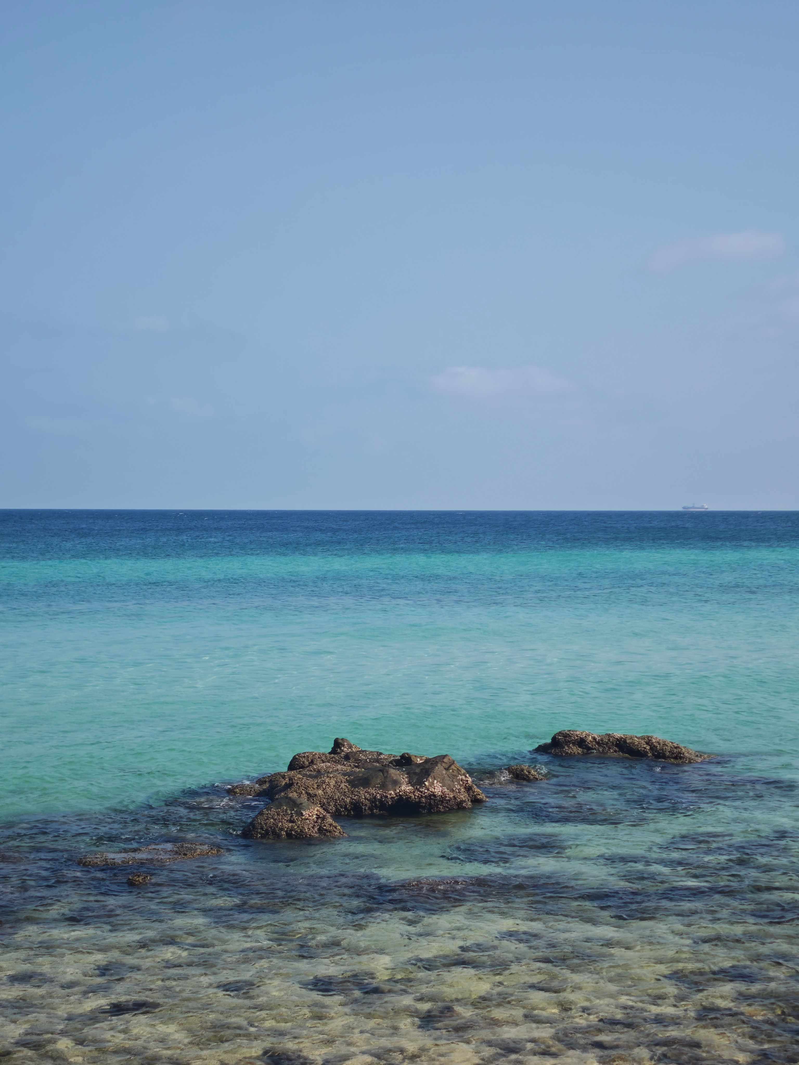 Tranquil Clear Blue Seascape with Rocky Outcrop
