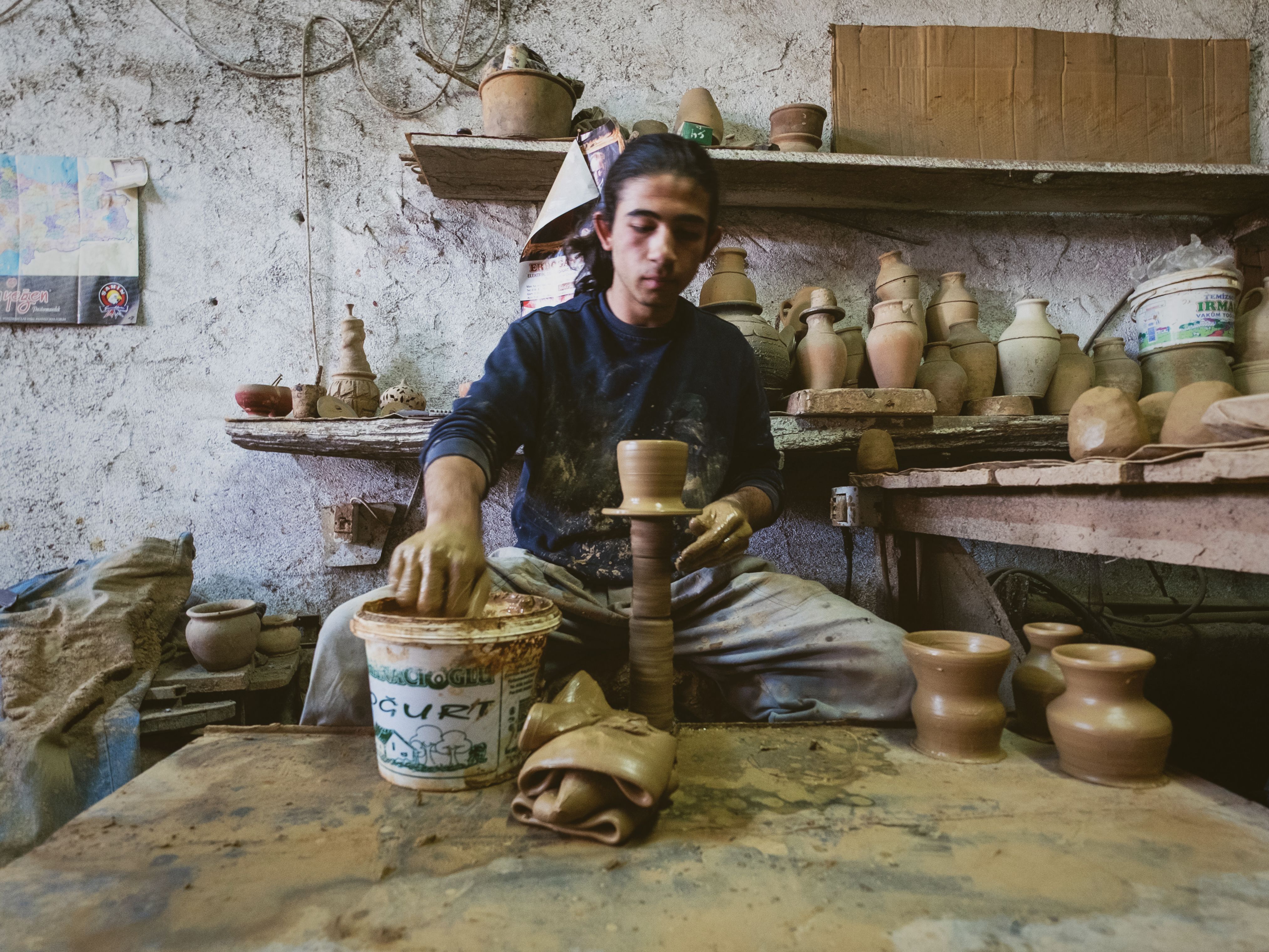 Artisan Crafting Pottery in Traditional Workshop