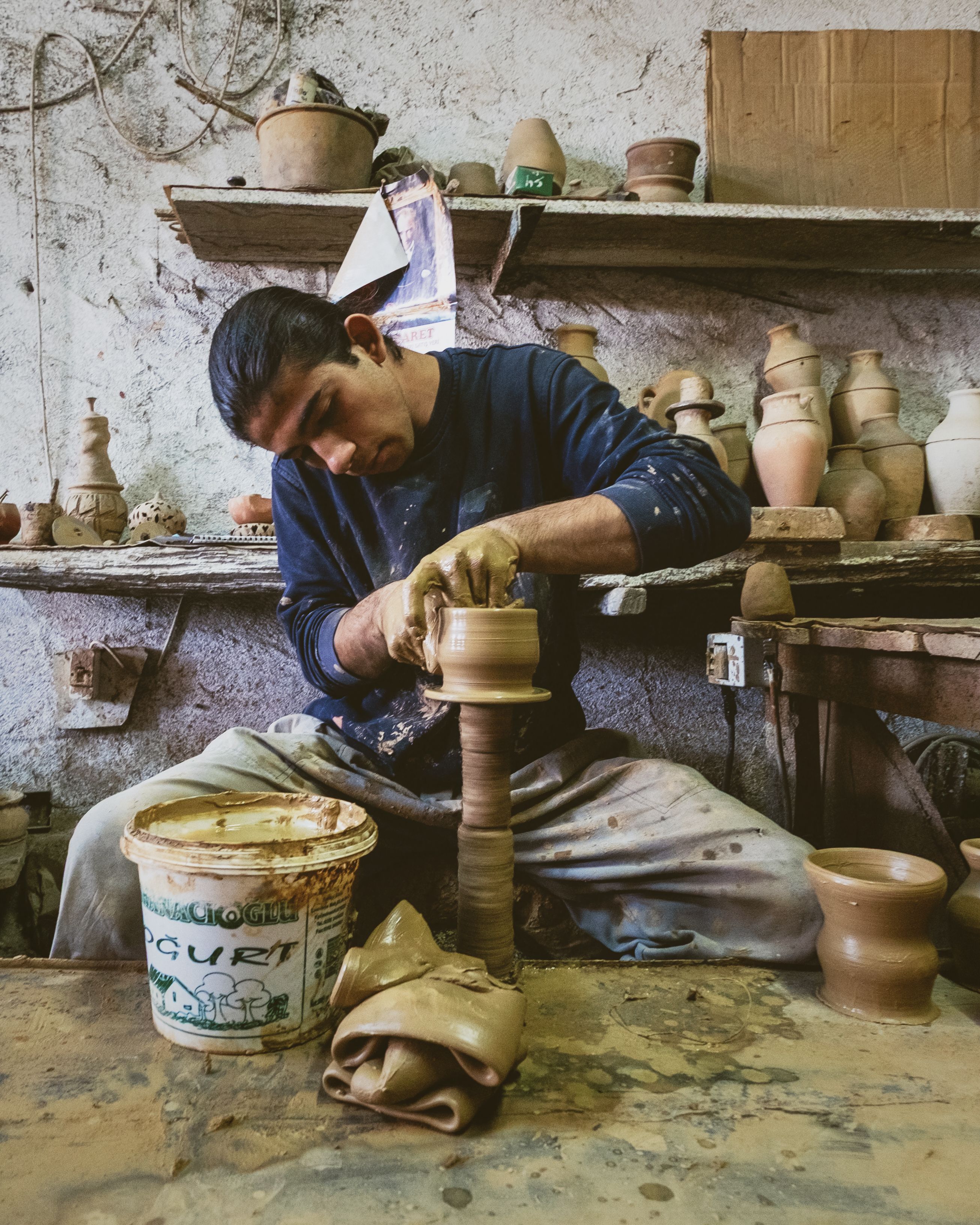 Artisan Crafting Pottery in Workshop Setting