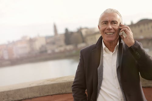 Man In Black Suit Talking To Someone