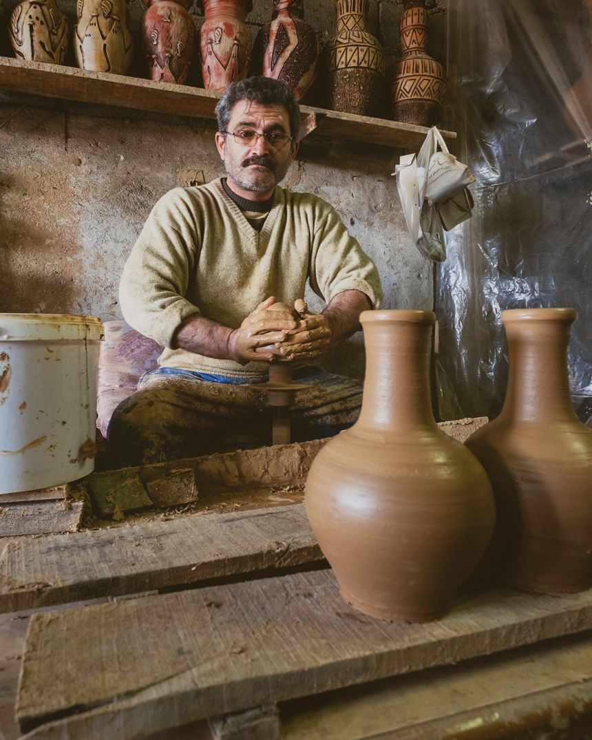 Camera preview — a potter shaping clay vases on a wheel in a workshop. Photo by Mehmet Turgut Kirkgoz on Pexels