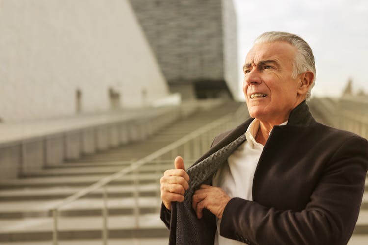 Elderly Man In Black Suit Standing Near Concrete Stairs